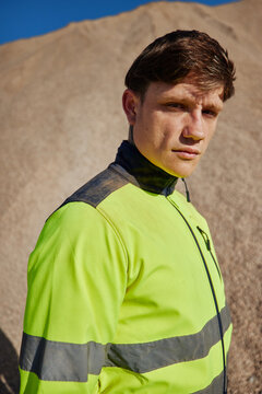 Young man in workwear on gravel