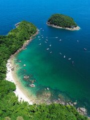 A stunning aerial perspective of Ilha das Couves, showcasing its crystal-clear turquoise waters,...