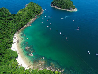 A stunning aerial perspective of Ilha das Couves, showcasing its crystal-clear turquoise waters,...
