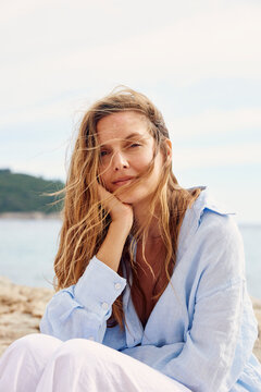 Portrait of a pensive woman by the sea