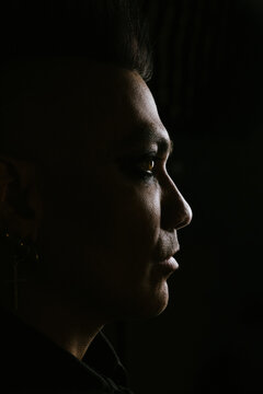 Dramatic male profile with mohawk in dark shadowy lighting