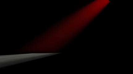 Obraz premium Single red spotlight creating an intense focal point against deep shadows.