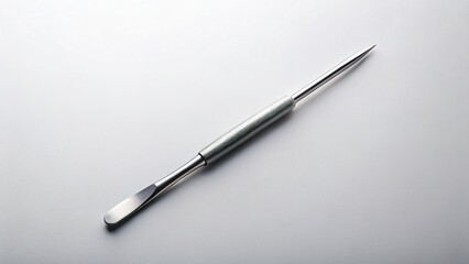 Modern Cuticle Pusher: Sleek Manicure Tool on Solid Background - Stock Photo