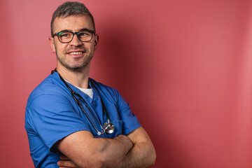 Healthcare professional with stethoscope poses confidently in clinical setting