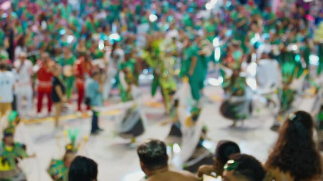 Brazilian carnival. Naturally blurred footage of the brazilian carnival and parade of school of samba performing on a sambodrome. People dance and celebrate on night parade of school of samba