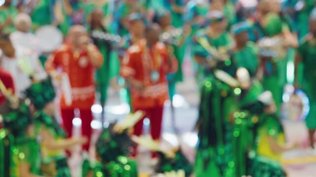 Brazilian carnival. Naturally blurred footage of the brazilian carnival and parade of school of samba performing on a sambodrome. People dance and celebrate on night parade of school of samba