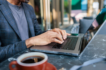 Entrepreneur working outside with laptop