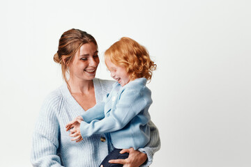 Mother and daughter embracing in front of a white background, love and bonding, family connection...