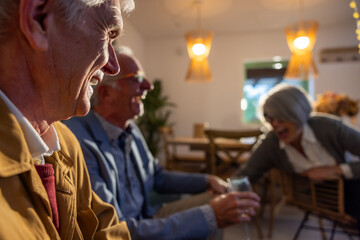 Joyful seniors enjoying conversation and laughter indoors