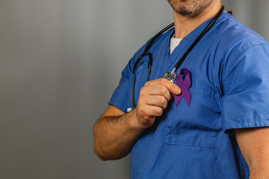 Medical professional wearing purple ribbon to raise awareness for health issues