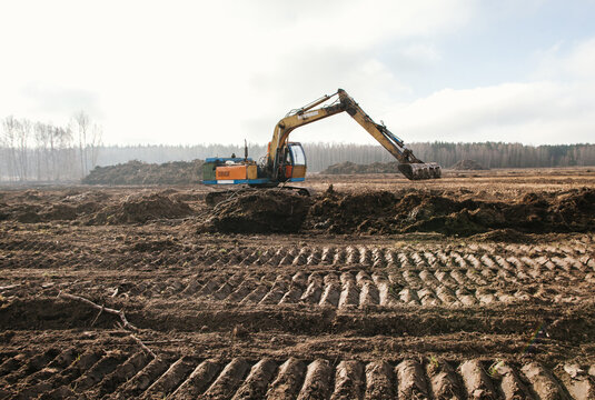 The excavator is leveling the ground.