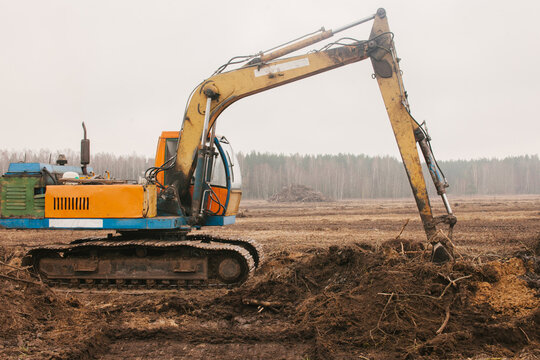 The excavator is leveling the ground.