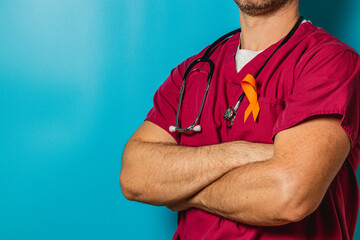 Health professional stands confidently wearing orange ribbon in solidarity