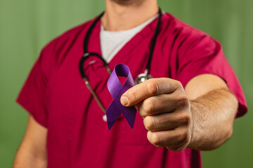 Fototapeta premium Health professional holding a purple awareness ribbon in a medical setting