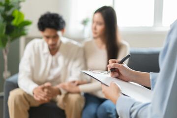 Spouses relationship consultant concept, Close-up hands of psychologist holding pen and note during...