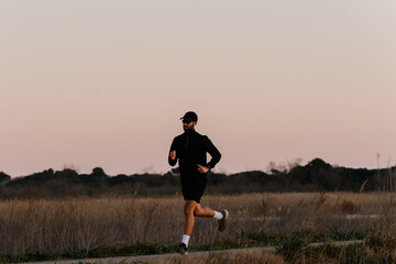 An adult fitness man enjoying a peaceful morning of outdoor exercise