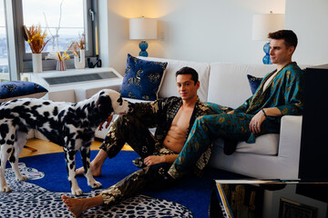Gay Couple Relaxing in Modern Living Room with Dalmatian
