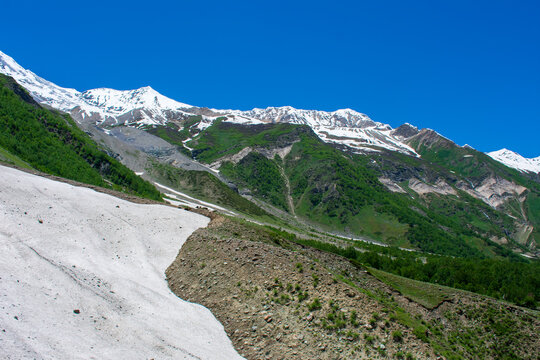 Scenic view of snow-capped mountains and lush green valleys in Dayitar Valley, Nagar, Gilgit, Pakistan, captured on June 20, 2023.