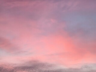 The evening sky is blue with multi-colored clouds, white, grey, pink, purple, golden yellow, orange, and vanilla.