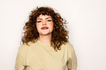 Confident curvy woman with curly hair and bold makeup