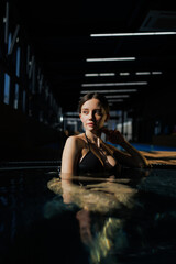 Pretty woman in swimsuit resting in hot tub 