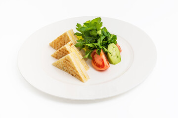 Toast with cheddar cheese and tomatoes and parsley on a white porcelain plate