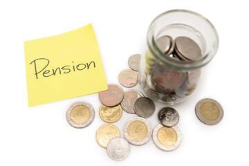 PENSION text on sticky note. Thai Baht Coins spilled out of jar glass isolated on white background,...
