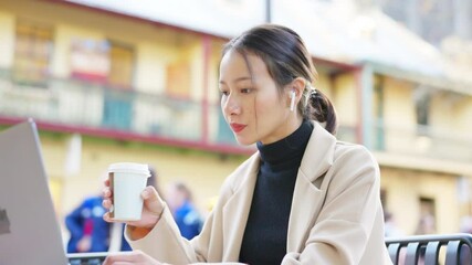 4K Confidence Asian businesswoman remote working on laptop computer outside office for online corporate business with using AI browsing data and speaking on mobile phone at outdoor cafe in the city. - Powered by Adobe