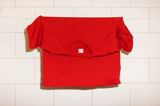 Red  t-shirt hanging on the  string 