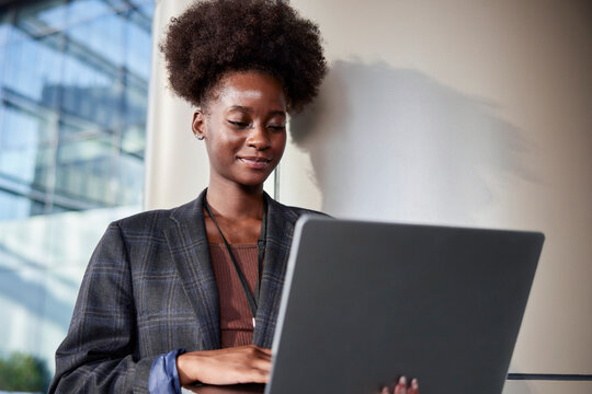 Woman making changes to presentation on laptop