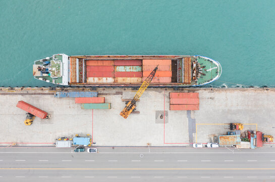 Aerial View of Cargo Ship Docked at Port with Containers