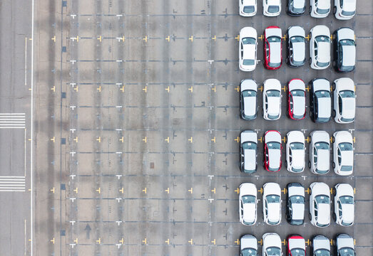 New Cars Neatly Parked in a Concrete Lot for Sale
