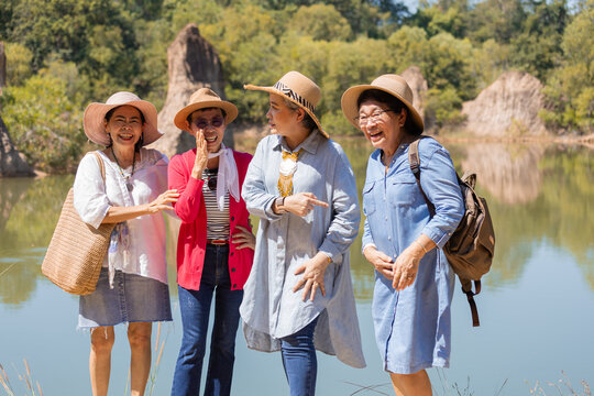 Group of Asian retirement women traveling, hiking, walking together in park, senior pensioner friends spend time exercise trekking outdoor, elderly tourist recreation relationship lifestyle day trip - Powered by Adobe