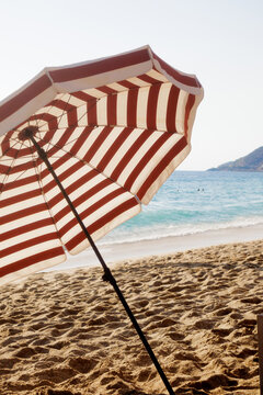 Beach umbrella on a sandy beach.