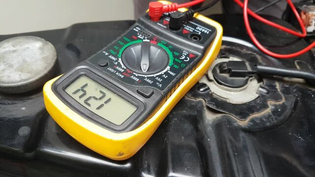 Digital multimeter to check the voltage level of fuses  in a vehicle to check  equipment malfunction in vehicle electric system.
