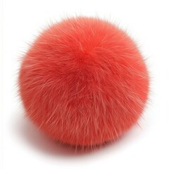 Bright orange fluffy pom pom ball resting on a flat surface with soft fibers reflecting light in a playful manner