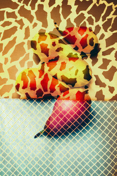 Art still life with pears on a background of print fabric