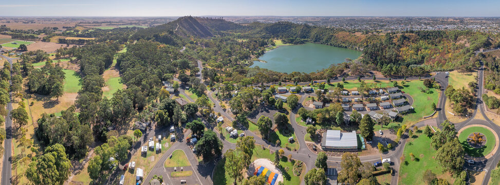 Caravan park around a green volcanic lake