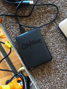 A hard drive with the word 'Confessions' written on it.