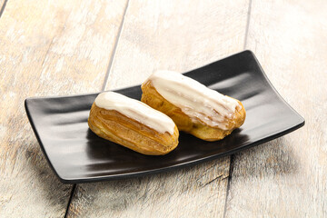 Delicous eclair with ising and cream