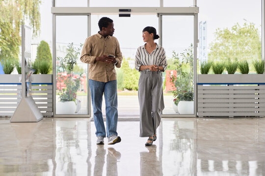 Male and female colleagues walking in office