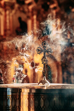 Cross enveloped in incense smoke during a religious ceremony