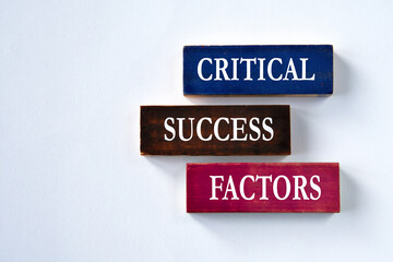 CRITICAL SUCCESS FACTORS - words on colorful wooden blocks on a grey background