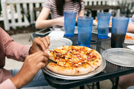 Dining: Woman Taking A Piece Of BBQ Pizza