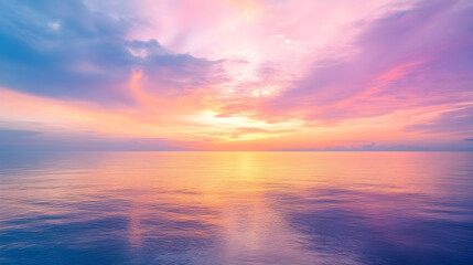 Fototapeta premium sky with tropical sunset colors fading into golden and lavender tones above calm waters 