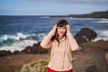 Smiling woman in windy coastal scenery