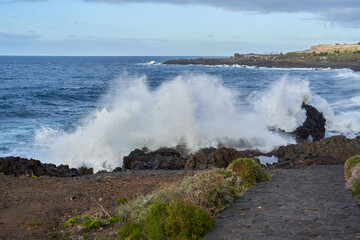 Waves crashing against volcanic rocks........