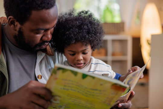 Dad reading to his son