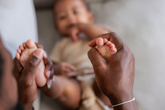 Dad holding baby's feet