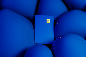 Bright blue credit card rests against a backdrop of vivid spheres
